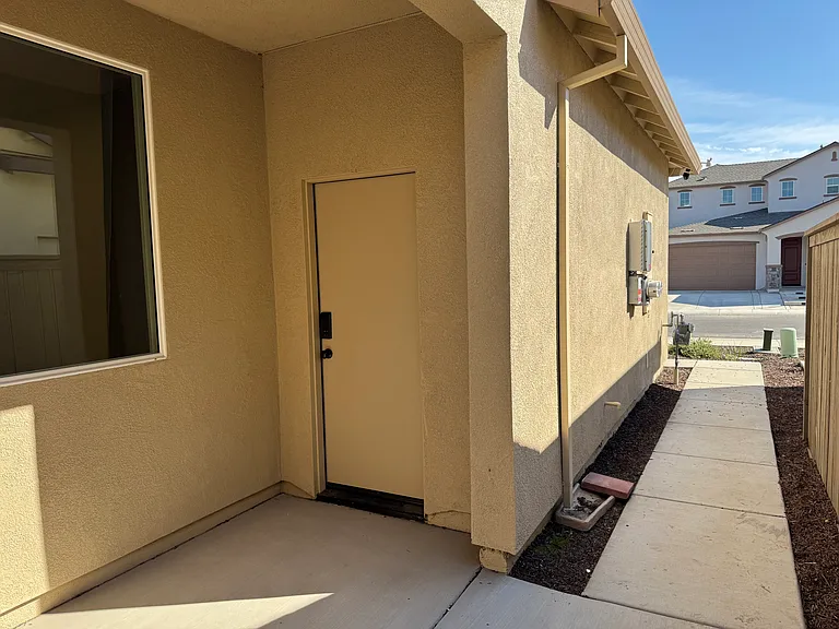 Door directly across from entrance door that leads to the 1-car garage bay.
