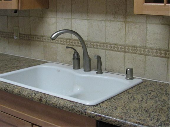 Granite counters with tile backsplash