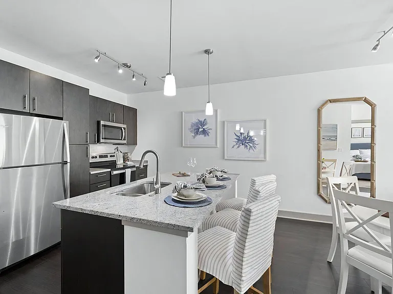 Contemporary Kitchen Featuring Granite Countertops and Pendant Lighting