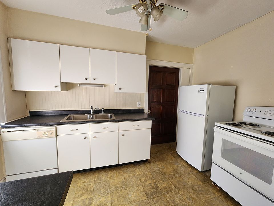 Kitchen with updated features and cabinets with dishwasher, fridge/freezer and range