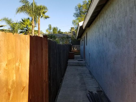 Concrete walkway on side of home