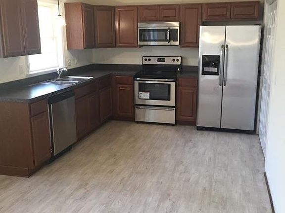 Kitchen with new cabinets, flooring, and stainless steel app