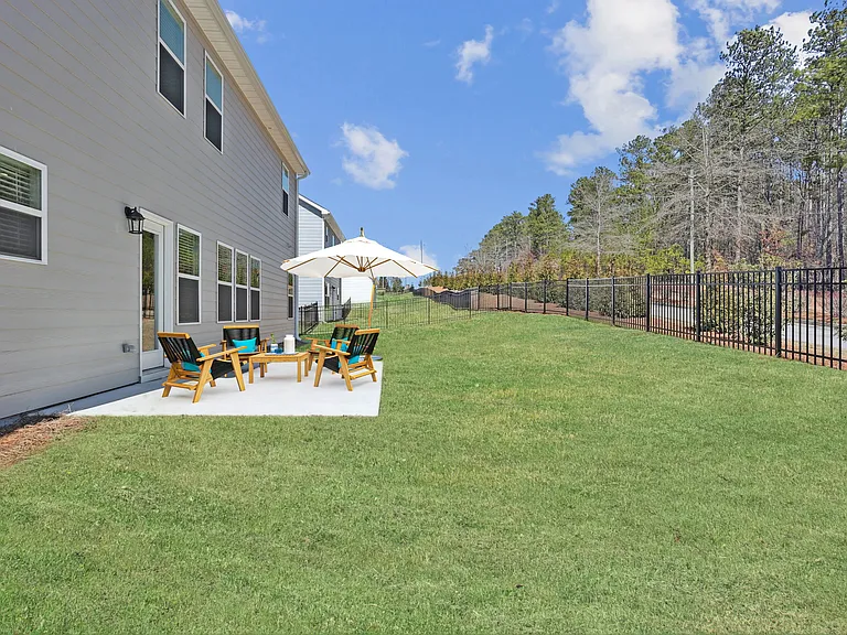 Back patio with fenced in yard.