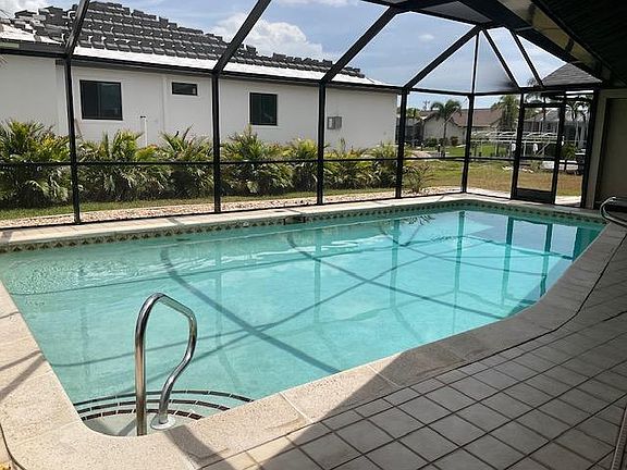 Beautiful pool and deck area overlooking canal.