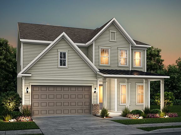 Continental exterior 19 features siding, brick accents, covered front porch and 2 car garage