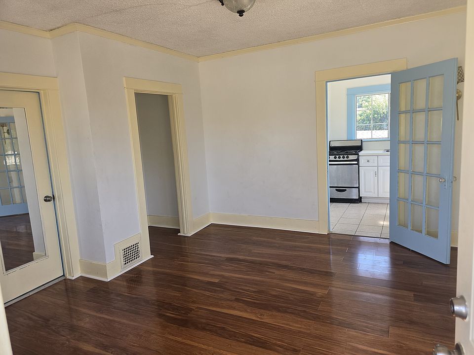 Living Room area different angle with kitchen ahead and bathroom to the left