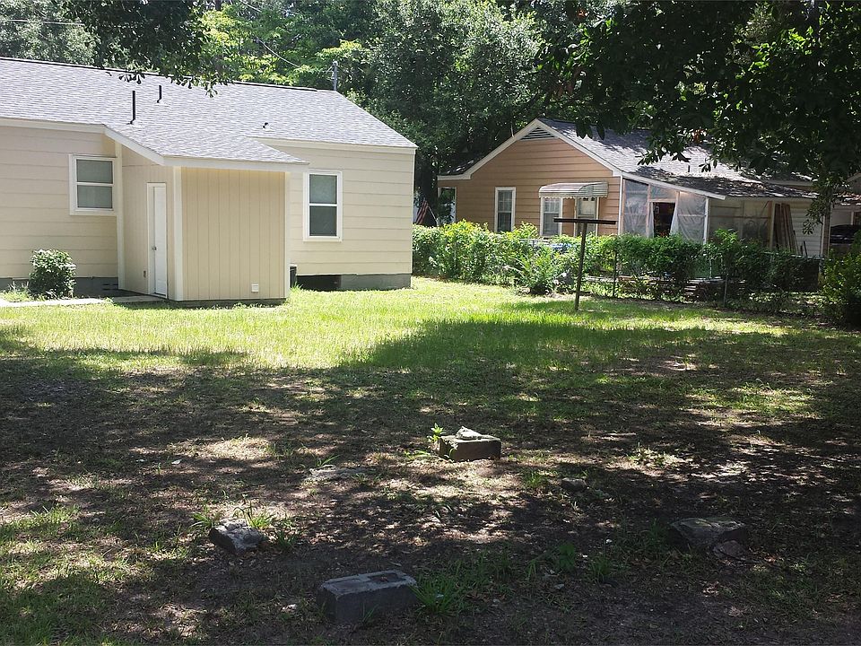 large fenced in back yard, with lots of shade