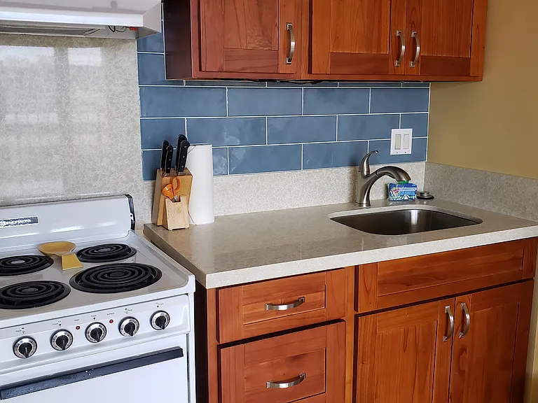 4 Burner Stove / Oven with typical large stainless sink and Natural stone counter tops