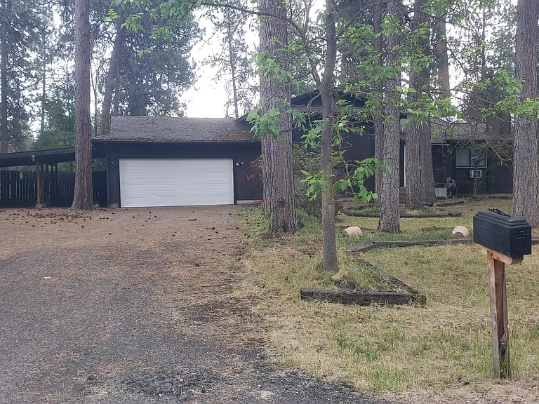 View from street - covered carport space in addition to garage and plenty of driveway parking spaces.