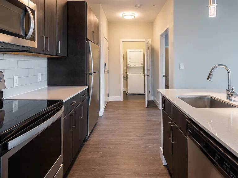 Kitchen with Stainless Steel Appliances and In-home Washer and Dryer
