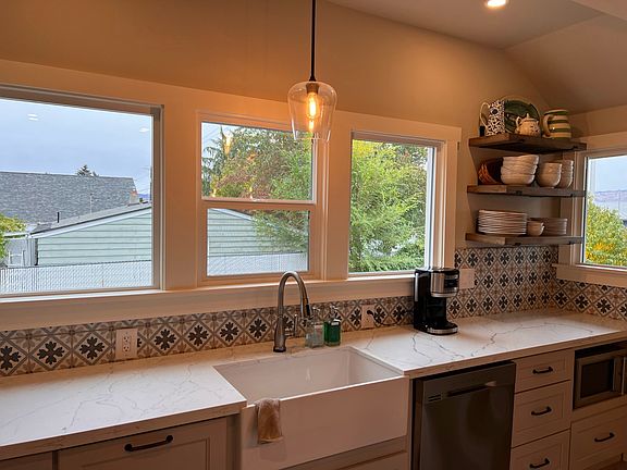 Farmhouse sink and windows overlooking the yard