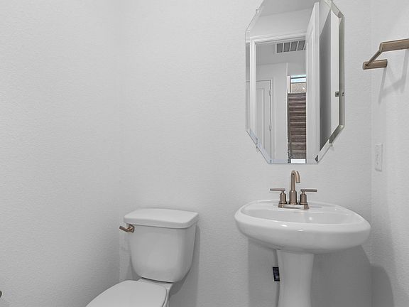 Convenient powder room located just off the living space for guests and everyday use.