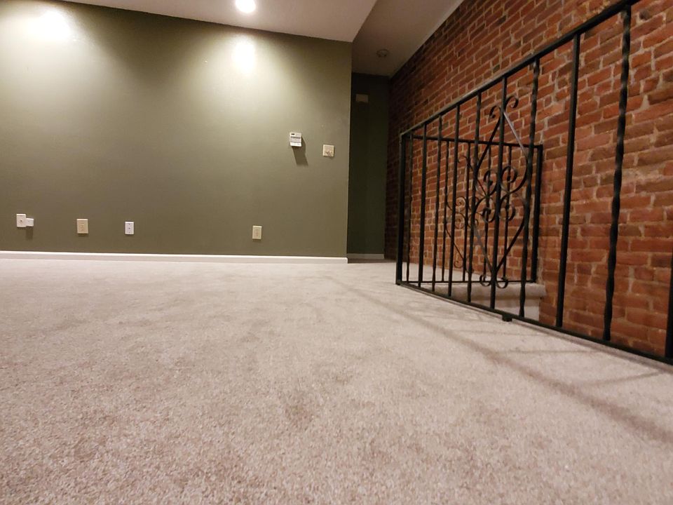 New carpet and exposed brick