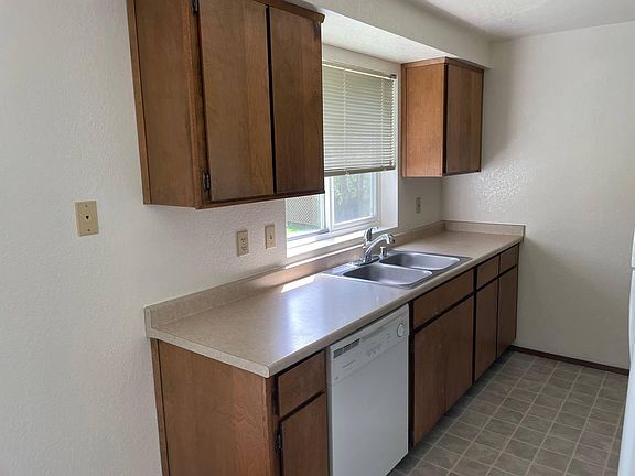Functional kitchen with ample cabinet storage and natural light