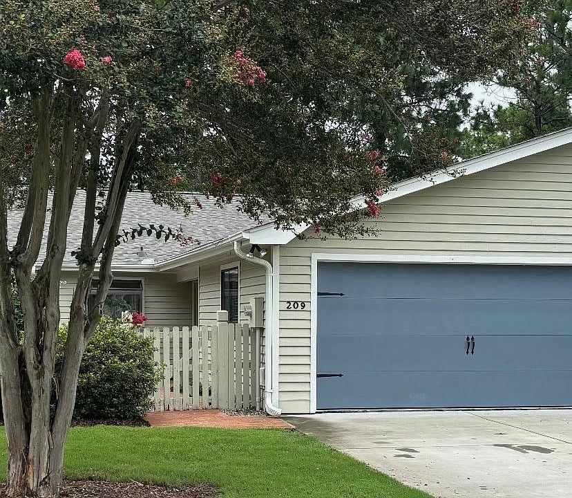Open the gate to an enclosed patio/entryway.