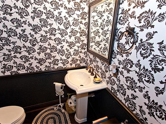 Half Bath with pedestal sink, wood floors and oil rubbed bronze fixtures.