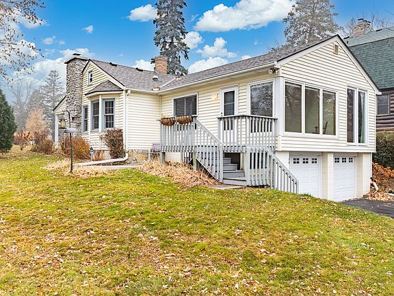 Big grassy yard. Deck, and steps that lead to the lake and another stairway that leads to a stone patio