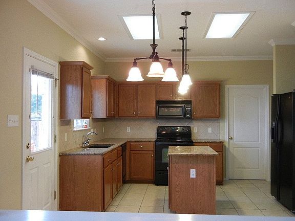 Kitchen Open To Family Room With Lovely Granite Counters And Center Island
