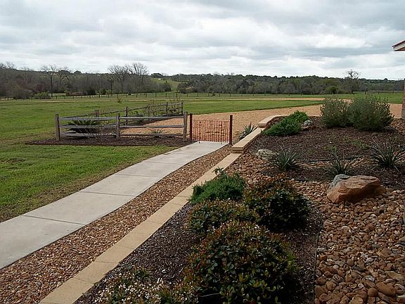 Landscaping in front and entry gate to front yard