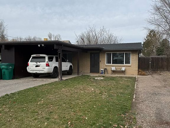 Front yard and parking space. There is a locked storage space in the car port.