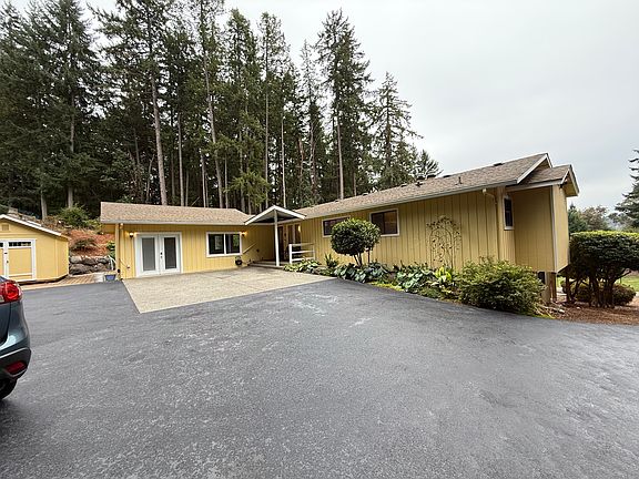 The second driveway takes you up and around to the upper floor and main entry door. The shed to the left is available for storage.