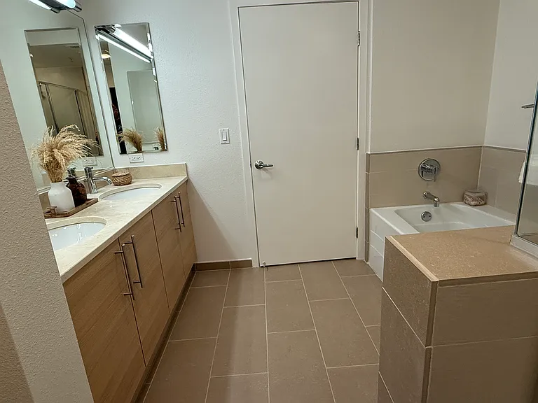 A spacious and elegant master bathroom featuring both a shower and a soaking tub.