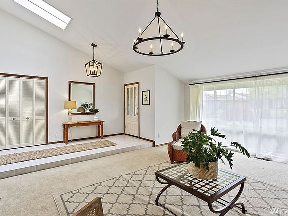Looking back toward the entry, you can admire the wall of windows, skylight and updated lighting.