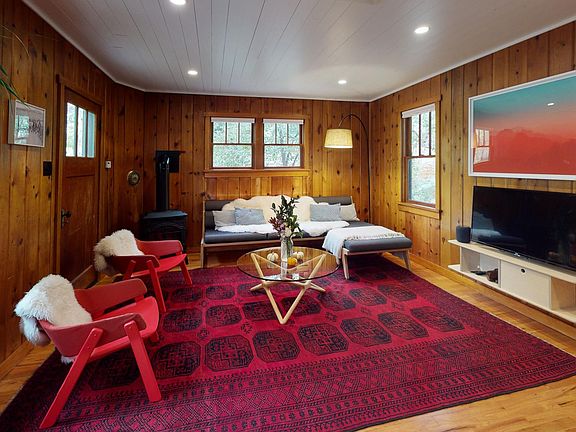 Living room with 4K HDTV, Apple TV, gas stove, and wireless stereo.