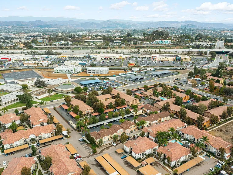 Aerial view of neighborhoods and shopping centers around The Nines Townhomes in Escondido, California.