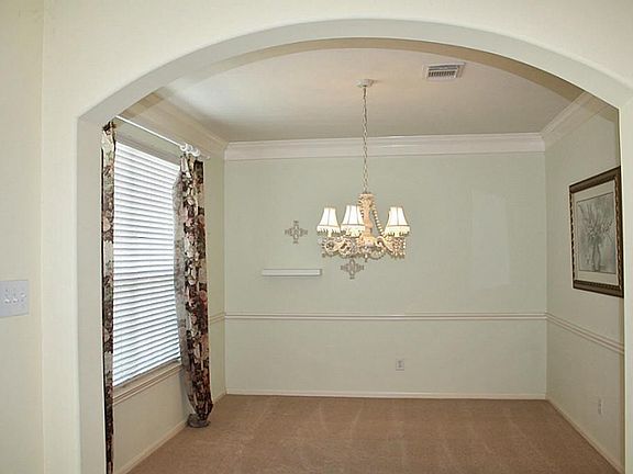 Formal Dining features Crown Molding; Open and Bright ; High Ceilings and Arched Doorway.
