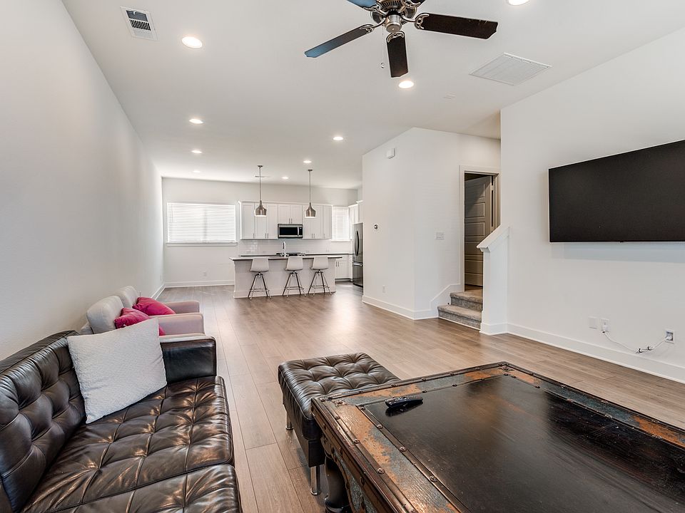 Spacious living area with large living room and full-sized kitchen with bar top, pantry, and built-in desk.