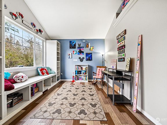 Located just off the entry this brightly lit room can be used as a dining room or as the current owner uses it as a play/office room.>