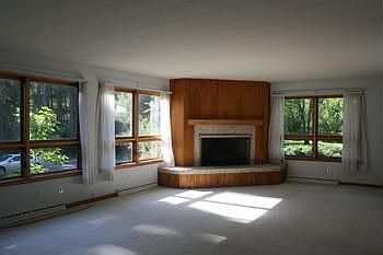Open, spacious Living Room featuring wall to wall windows with elevated views of this fantastic property!
