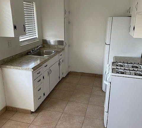 Kitchen with eating area. Refinished cabinets, new countertops, new refrigerator and gas stove.