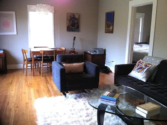 living room includes couch, piano, dining room table / chairs.