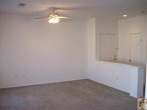View of the living room from the dining area. The entry do