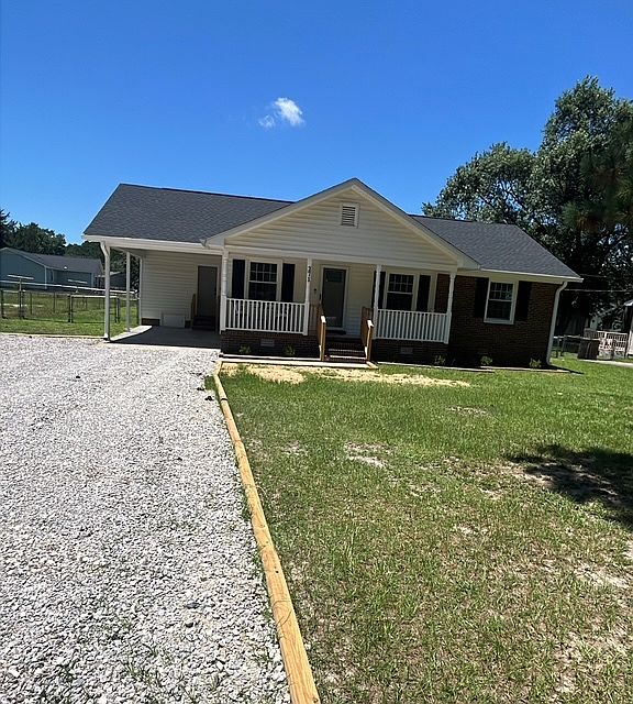 Front of house with attached carport. Enough parking space for 4 vehicles.