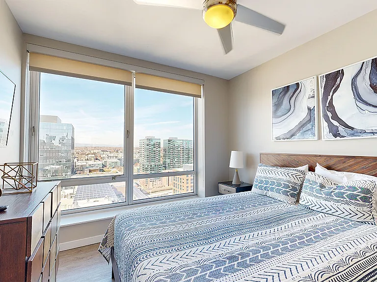 Spacious apartment bedroom with wood-style flooring.