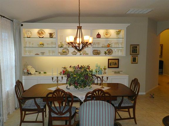 Charming formal dining room with wall of custom built-ins.