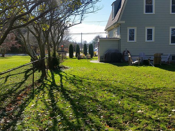 Partially fenced rear yard with a "potting shed" and a garag
