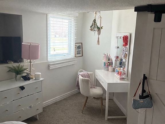Downstairs bedroom with closet and under stairs storage.