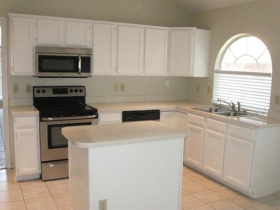 Large Island Kitchen. Freshly Painted Cabinets. Stainless St