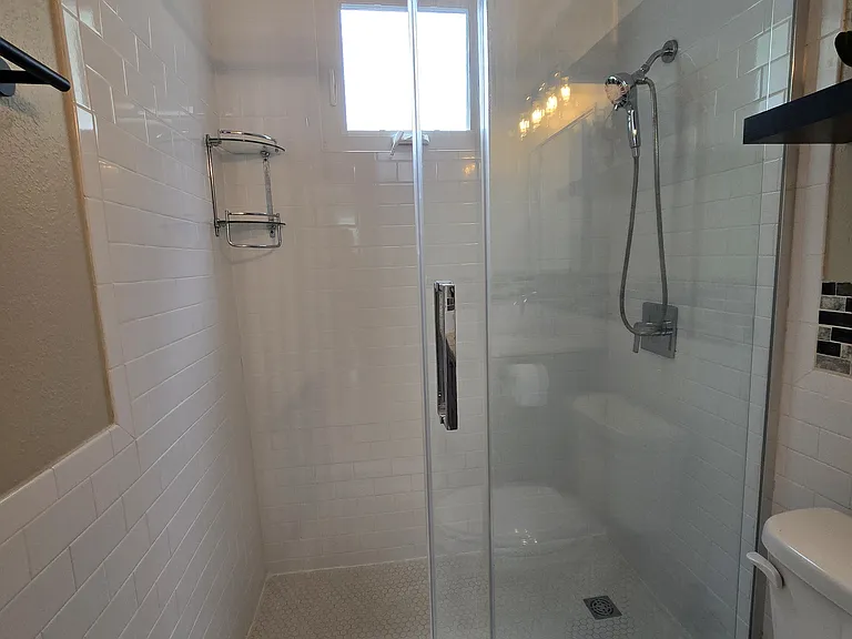Tiled shower with sliding glass door