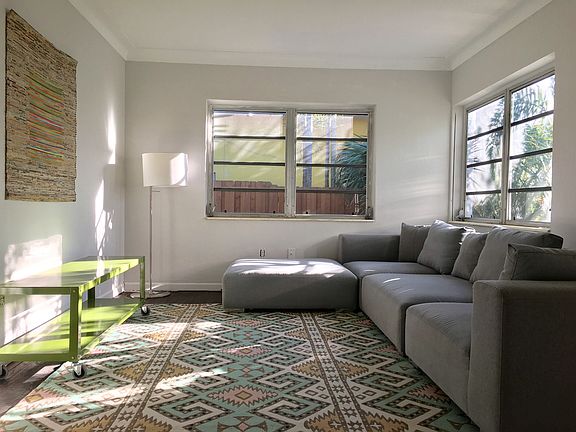 Living room with gorgeous Design Within Reach sofa and ottom