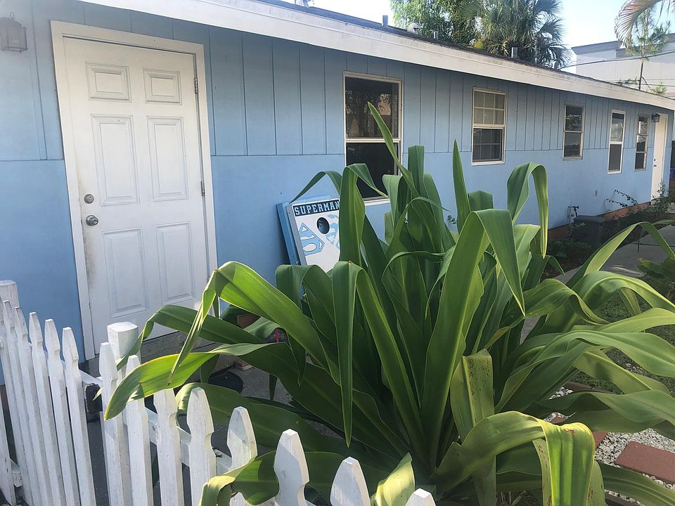 Front of duplex with fenced in yard