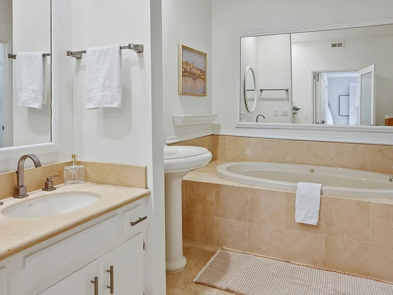 Primary ensuite bathroom with jacuzzi tub.