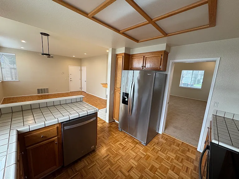 Kitchen w/ Living room (left) and dining room entry (right)