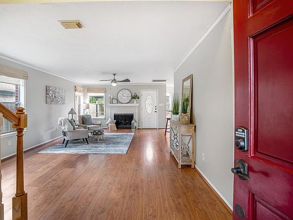 Come on in! As you enter the home you are immediately greeted by the bright and open space that makes up the living room. Gorgeous laminate wood floors flow through the main areas of the home.