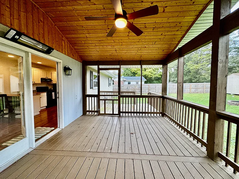 Covered and screened in back porch with heater and ceiling fan