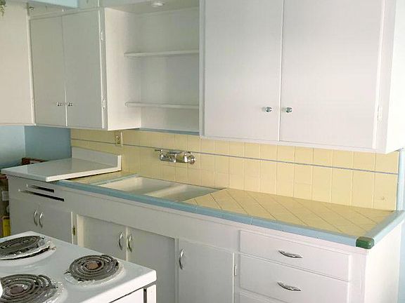 Kitchen with original 1940s vintage cabinet paintings.